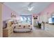 Bedroom with a large window, neutral carpet, and an ensuite bath at 1441 Olde Kensington Ln, Deltona, FL 32725