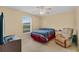 Cozy bedroom with a window, a comfy armchair and a neutral color palette at 1441 Olde Kensington Ln, Deltona, FL 32725