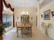 Elegant dining room boasting tray ceilings, large windows, chandelier, and decorative built ins at 1441 Olde Kensington Ln, Deltona, FL 32725