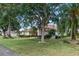 Landscaped front lawn featuring mature shade trees, manicured shrubs, and a well maintained lawn at 1441 Olde Kensington Ln, Deltona, FL 32725