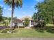 Inviting home with lush lawn, mature trees, and decorative landscaping enhancing curb appeal at 1441 Olde Kensington Ln, Deltona, FL 32725