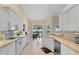 Kitchen featuring a breakfast bar and views into the dining area at 1441 Olde Kensington Ln, Deltona, FL 32725