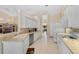 Well-lit kitchen featuring a suite of white appliances and tile countertops at 1441 Olde Kensington Ln, Deltona, FL 32725