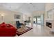 Spacious living room with fireplace, tile floors, and sliding glass doors to outdoor patio at 1441 Olde Kensington Ln, Deltona, FL 32725