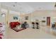 Open-concept living room with tile floors, a breakfast bar, and plenty of natural light at 1441 Olde Kensington Ln, Deltona, FL 32725