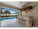 Outdoor bar with a view of the screened-in pool and patio at 1441 Olde Kensington Ln, Deltona, FL 32725