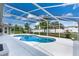 Screened in pool and patio area surrounded by lush greenery at 1441 Olde Kensington Ln, Deltona, FL 32725