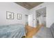 Bright bedroom with hardwood floors, a modern interior, and a view of the dining room and bathroom at 155 S Court Ave # 1305, Orlando, FL 32801