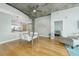 Open concept living area with concrete ceilings and dining table with bright natural light at 155 S Court Ave # 1305, Orlando, FL 32801