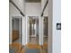 Hallway with mirrored closet doors leading to the bathroom and other rooms, enhancing the sense of space at 155 S Court Ave # 1305, Orlando, FL 32801