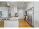 Modern kitchen featuring stainless steel appliances, white cabinetry, and a marble countertop island at 155 S Court Ave # 1305, Orlando, FL 32801