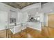 Modern kitchen and dining area with white cabinets, stainless steel appliances, and concrete ceilings at 155 S Court Ave # 1305, Orlando, FL 32801