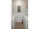 A functional laundry room with a stacked washer and dryer and clean white walls at 155 S Court Ave # 1305, Orlando, FL 32801