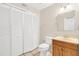 Well-lit bathroom featuring tiled floors, updated vanity, toilet, and mirrored medicine cabinet at 1612 Sandy Point Sq # 56, Orlando, FL 32807