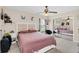 Comfortable bedroom features a ceiling fan, plush bed, mirrored closet doors, and natural light at 1612 Sandy Point Sq # 56, Orlando, FL 32807