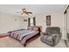 Nicely decorated bedroom features a comfortable bed, ceiling fan, and natural light at 1612 Sandy Point Sq # 56, Orlando, FL 32807
