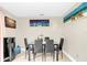 Bright dining room features modern table set, neutral walls adorned with stylish artwork, and tiled floor at 1612 Sandy Point Sq # 56, Orlando, FL 32807