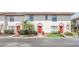Charming townhome featuring a red door, manicured landscaping, and a private front entrance at 1612 Sandy Point Sq # 56, Orlando, FL 32807