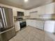 Well-lit kitchen featuring stainless steel appliances and ample counter space at 1612 Sandy Point Sq # 56, Orlando, FL 32807