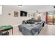 Spacious living room featuring a sectional sofa, ceiling fan, and sliding glass doors to the patio at 1612 Sandy Point Sq # 56, Orlando, FL 32807