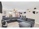 Comfortable living room with a large sectional sofa and access to the dining area at 1612 Sandy Point Sq # 56, Orlando, FL 32807