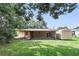 Spacious backyard featuring a screened in porch and storage shed at 17 W Nightingale St, Apopka, FL 32712
