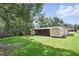Wide backyard showing a patio, shed, and fenced green space at 17 W Nightingale St, Apopka, FL 32712