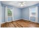 Bedroom featuring wood floors, two windows with neutral paint and natural light at 17 W Nightingale St, Apopka, FL 32712