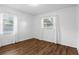 Bright bedroom with wood floors, large windows, and fresh white paint at 17 W Nightingale St, Apopka, FL 32712