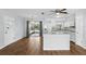 Dining area with wood floors that connects to a bright kitchen and screened patio at 17 W Nightingale St, Apopka, FL 32712