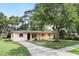 Inviting single-story home with a lush front yard and large shade tree at 17 W Nightingale St, Apopka, FL 32712