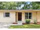 Inviting entrance to home with dark wood door and detailed trim at 17 W Nightingale St, Apopka, FL 32712