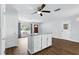 Open floor plan of living room with central island, natural light, and wooden floors at 17 W Nightingale St, Apopka, FL 32712