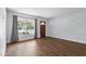 Inviting living room featuring wood floors, a large window, and neutral wall paint at 17 W Nightingale St, Apopka, FL 32712