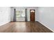 Bright living room showcases beautiful wood-look floors and natural light from the window at 17 W Nightingale St, Apopka, FL 32712