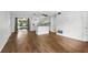 Open living space featuring wood flooring, sliding glass doors and kitchen access at 17 W Nightingale St, Apopka, FL 32712