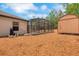 Home exterior featuring a screened-in pool and storage shed at 1861 E Glancy Dr, Deltona, FL 32725