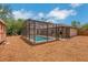 Backyard showcasing a screened-in pool, storage shed, and plenty of open space at 1861 E Glancy Dr, Deltona, FL 32725