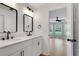 Bathroom with double sinks and view of bedroom with lots of natural light at 1861 E Glancy Dr, Deltona, FL 32725