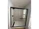 Modern bathroom with glass shower featuring a black frame and updated fixtures at 1861 E Glancy Dr, Deltona, FL 32725