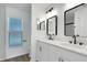 Modern bathroom with double sink vanity, marble countertops, and sleek black fixtures at 1861 E Glancy Dr, Deltona, FL 32725