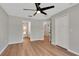 Bedroom featuring wood floors, ceiling fan, closet, and multiple doorways at 1861 E Glancy Dr, Deltona, FL 32725