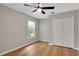 Neutral bedroom featuring wood-look flooring, ceiling fan, natural light, and closet at 1861 E Glancy Dr, Deltona, FL 32725