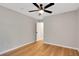 Neutral bedroom featuring wood-look flooring, ceiling fan, and natural light at 1861 E Glancy Dr, Deltona, FL 32725