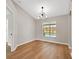 Dining room with wood floors and designer lighting, next to open doorway to another room with a pool view at 1861 E Glancy Dr, Deltona, FL 32725