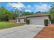 This single-story home features a well-maintained exterior, attached garage, and driveway at 1861 E Glancy Dr, Deltona, FL 32725