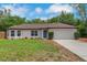 Charming single-story home featuring a manicured lawn, classic facade, and attached two-car garage at 1861 E Glancy Dr, Deltona, FL 32725