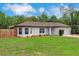 Charming single-story home with manicured lawn, bay window, mature landscaping, and two-car garage at 1861 E Glancy Dr, Deltona, FL 32725