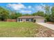 Charming single-story home featuring a manicured lawn, classic facade, and attached two-car garage at 1861 E Glancy Dr, Deltona, FL 32725