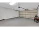 Spacious two-car garage with painted floors, offering ample room for parking and storage at 1861 E Glancy Dr, Deltona, FL 32725